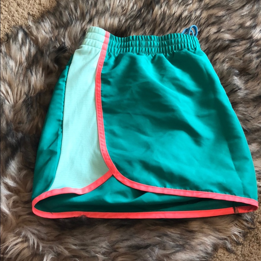 Turquoise and neon coral running shorts